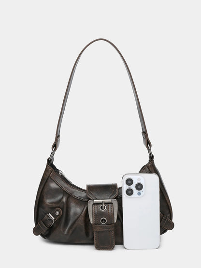 Y2K style leather shoulder bag in earthy tones, featuring a pocket detaling and a smartphone for scale.